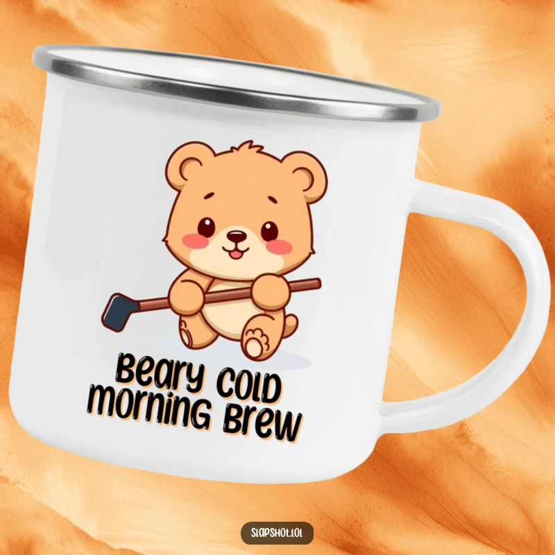 Funny camping mug showcasing a happy bear cub with a hockey stick playfully batting a puck, ideal for outdoor sports fun.