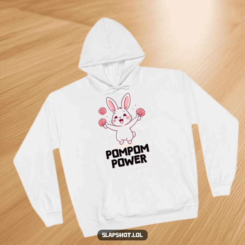 Funny rabbit character on a hoodie, enthusiastically cheering with pom-poms, a warm and humorous fan item.